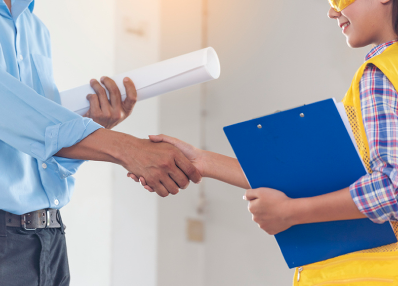 Professionals shaking hands, holding clipboard
