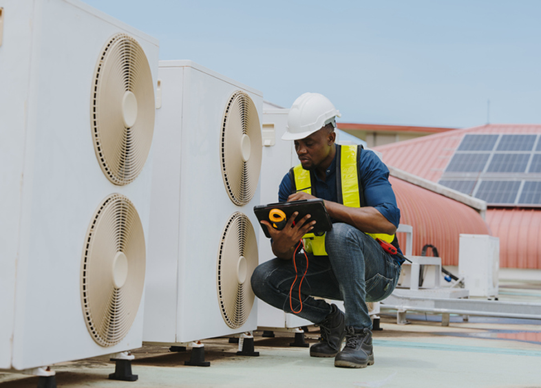 Engineer with tablet checks HVAC systems