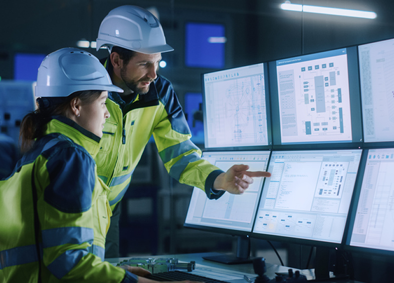 Industrial workers reviewing technical plans