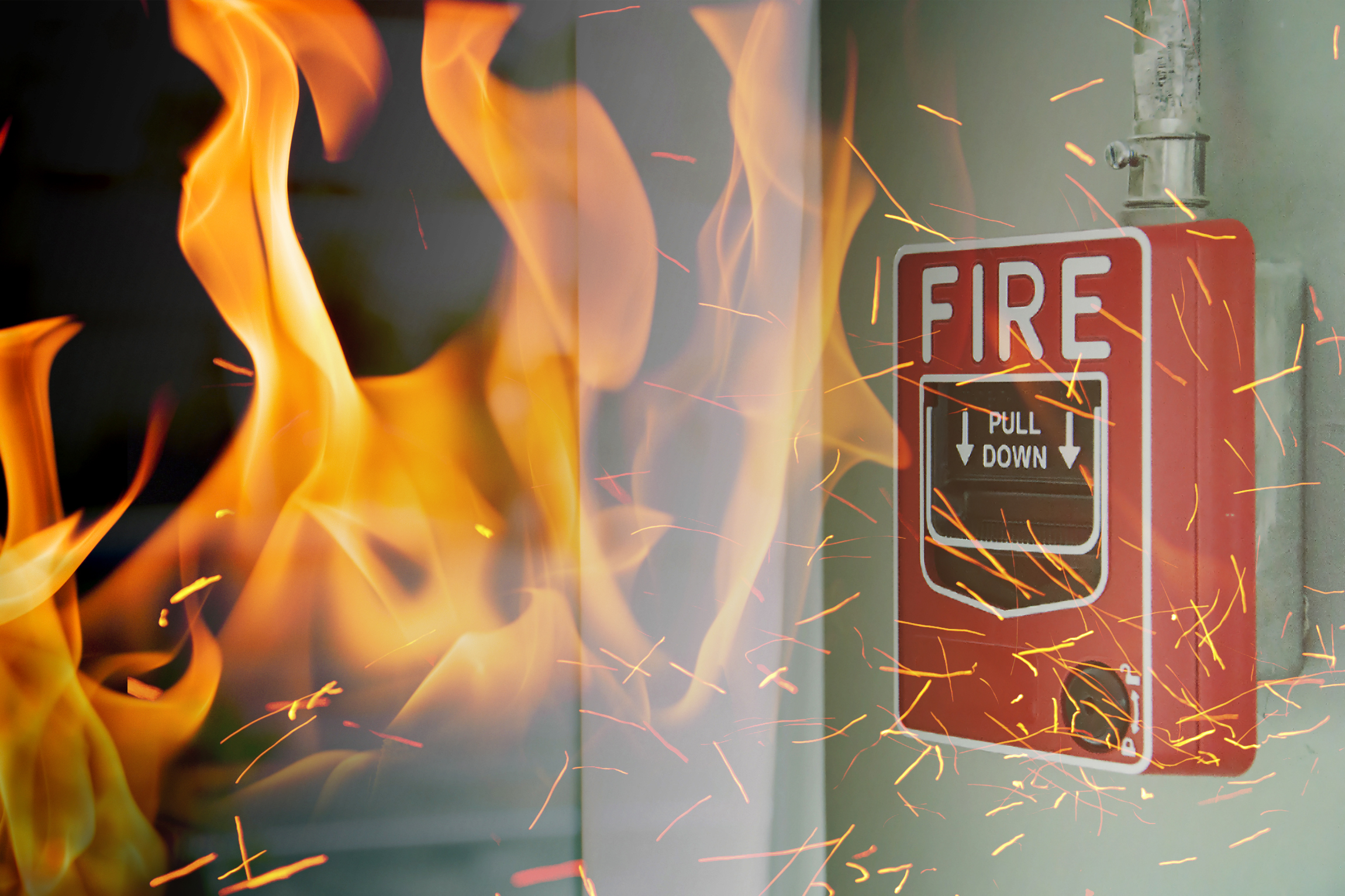Fire alarm with flames in background.