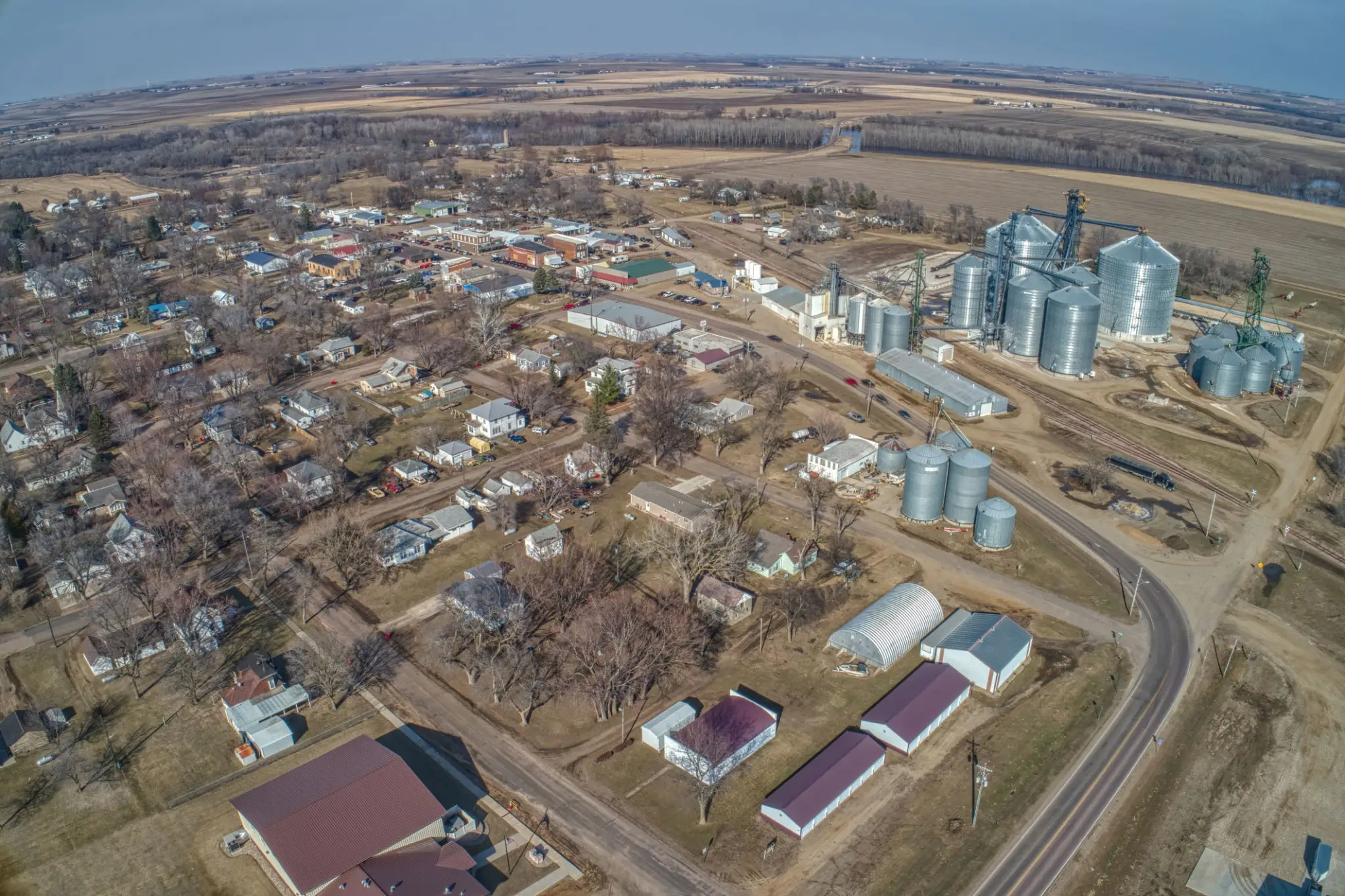 Aerial view of rural town and silos.