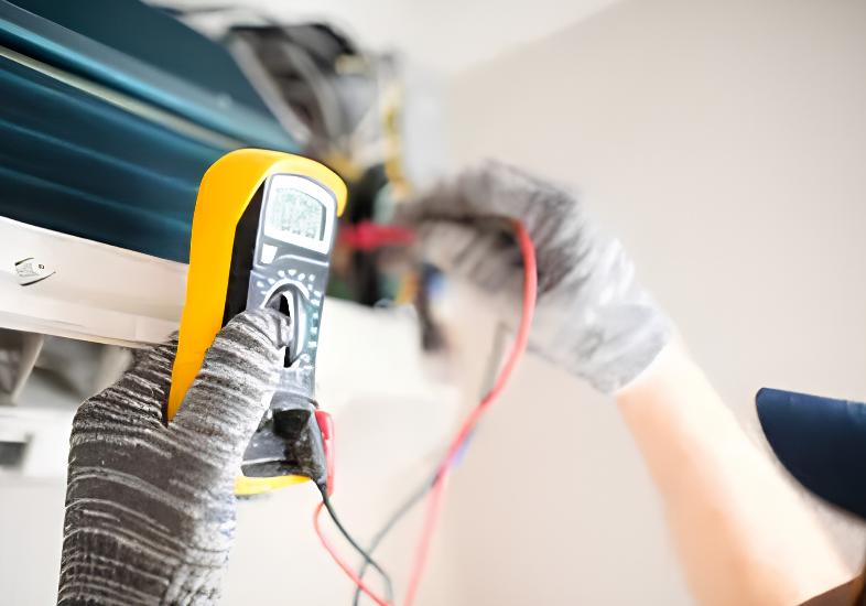 Technician using multimeter on air conditioner unit.